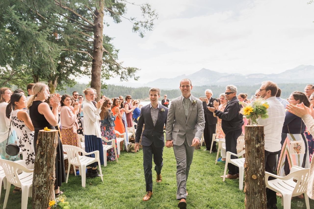 A candid photo of a gay wedding couple at their wedding ceremony