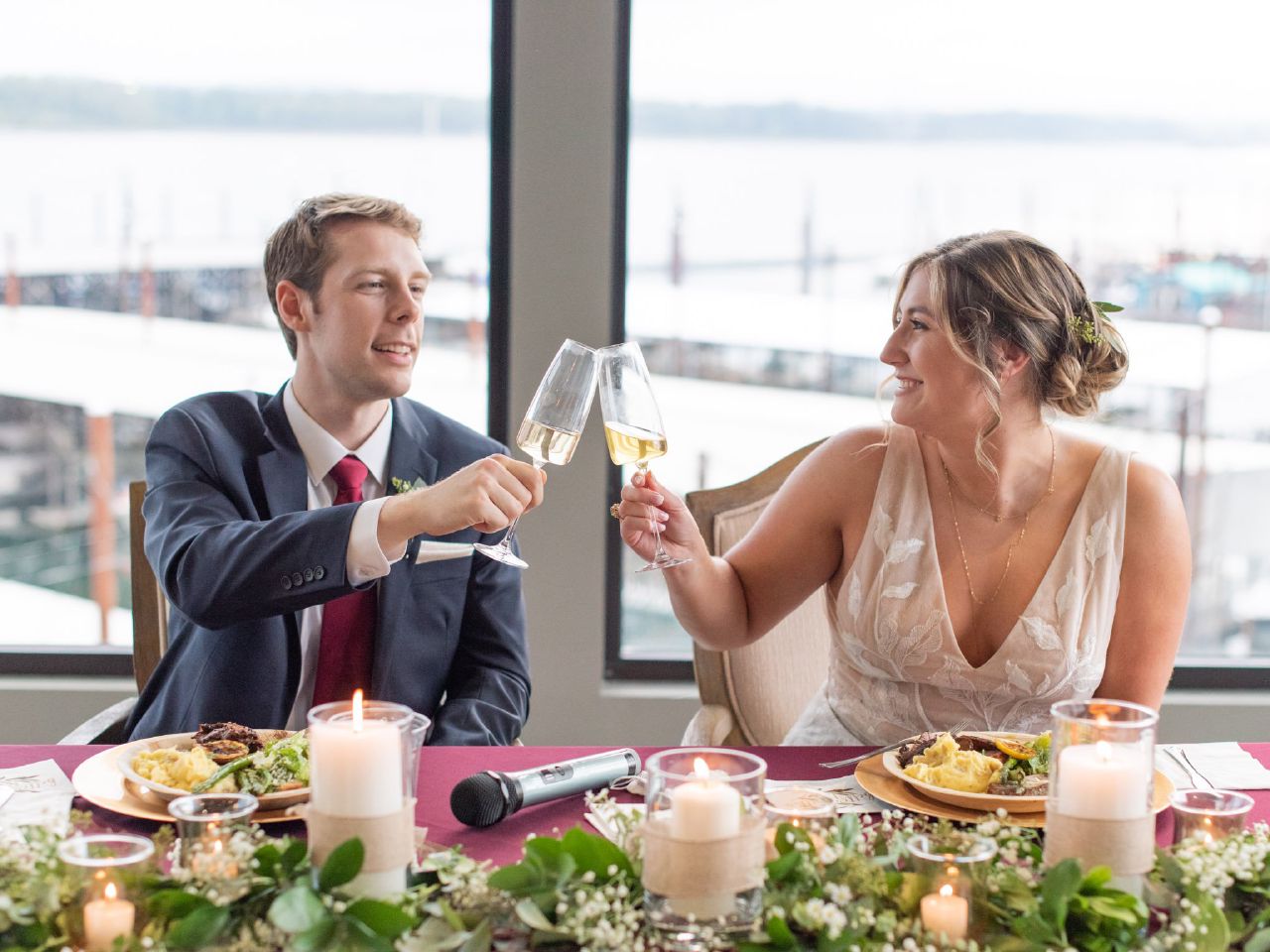 A bride and groom giving cheers with champagne