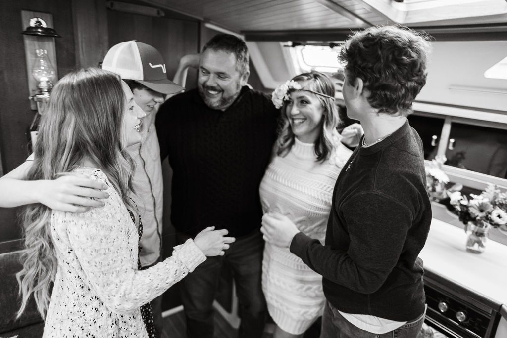 A family gathers at a wedding on a sailboat in Olympia, Washington