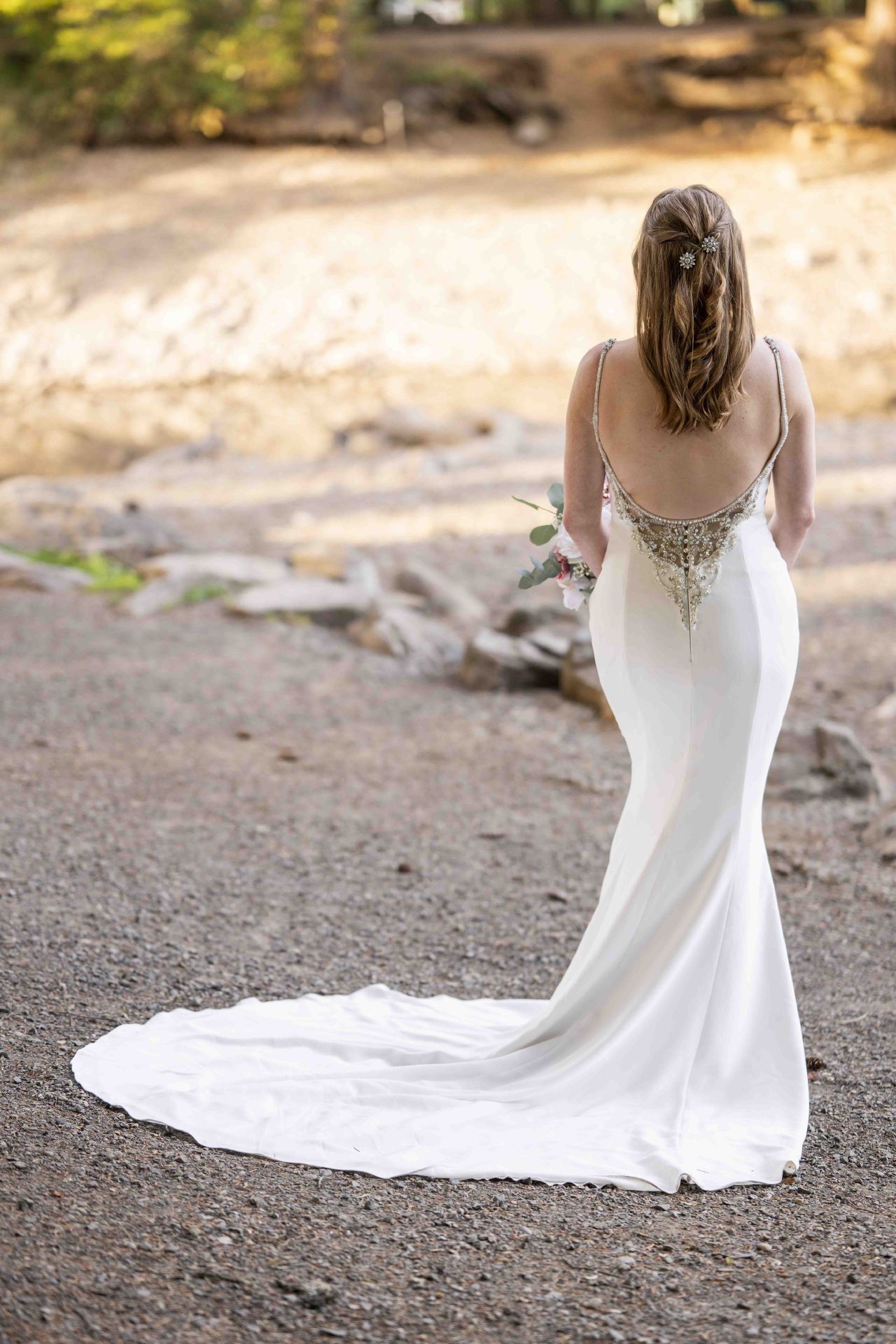Back view of bride’s gown with jeweled detailing and long train at Lacamas Lake Park Camas WA.